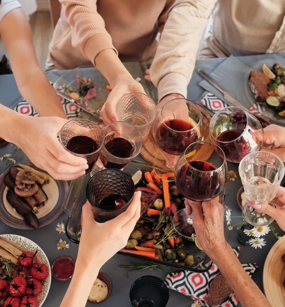 People cheering wine glasses